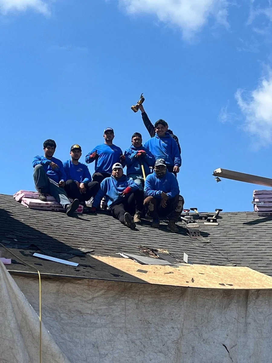 Bakeris crew gathered on a roof during a roofing project