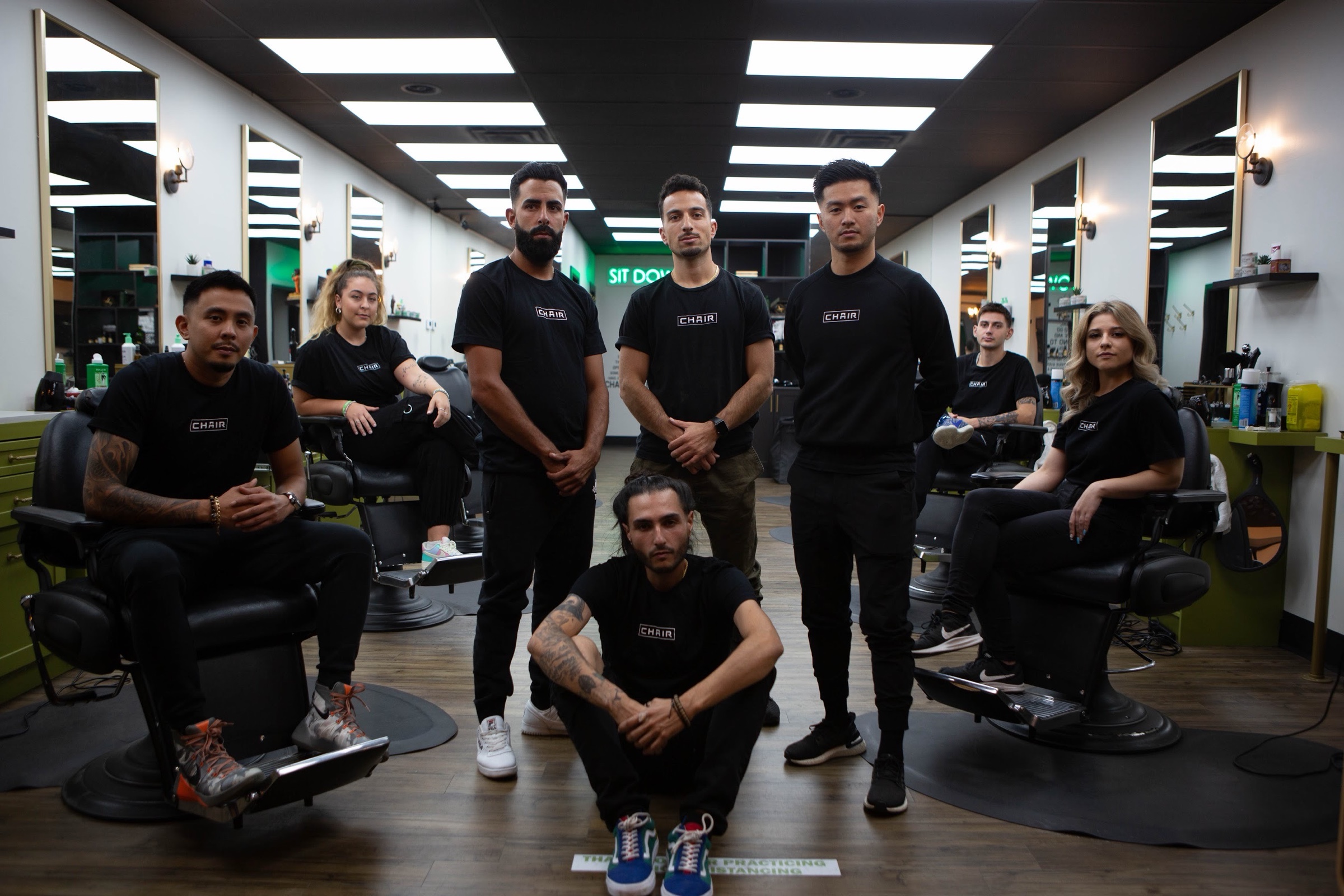 The Chair team posed in the shop, all in CHAIR-branded tees