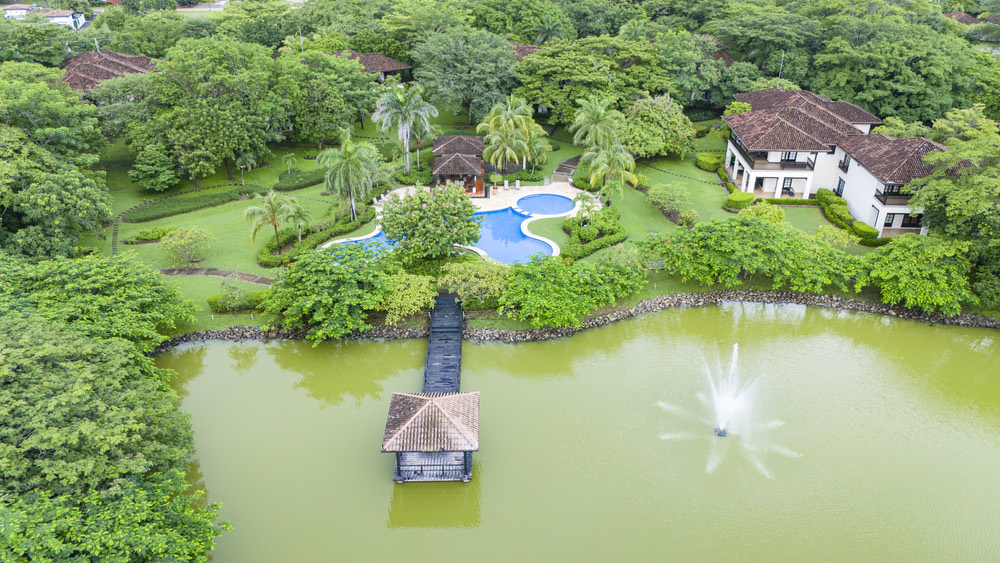 Aerial view of the lagoon, residences, and pool at Hacienda Pinilla
